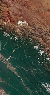 Aerial shot of desertification region. Camera is zooming in, rotating counterclockwise. Vertical video. Animation based on image by NASA