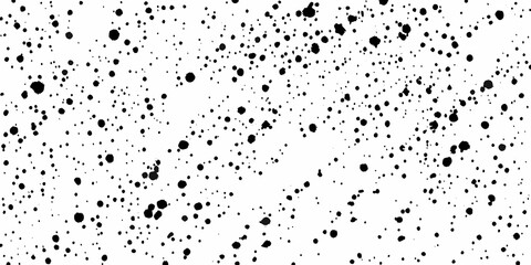 Obraz premium Abstract splatter pattern with varying sizes of black ink dots on white