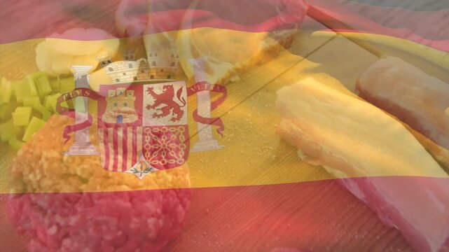 Camera panning, focus pulling prompt food shifting, revealing textures beneath Spanish flag overlay