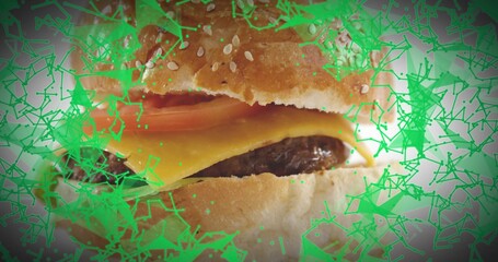 Showing closeup burger sitting on table, melted cheese, patty, tomato, sesame bun, green overlay © vectorfusionart