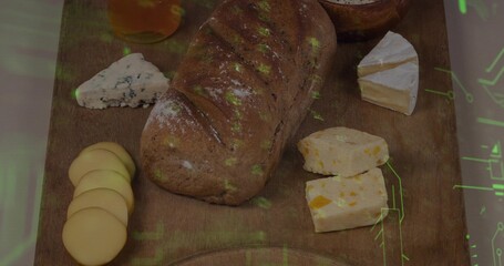 Showing artisan loaf centered on wood board with various cheeses, honey, green overlay