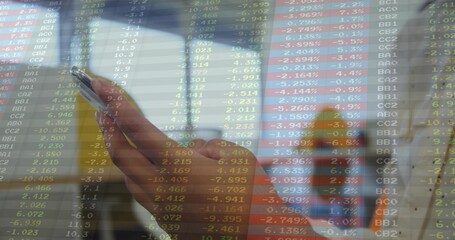 Holding single hand with orange sleeve, viewing smartphone in train, with stock data overlay