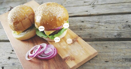 Displaying two sesame brioche sliders resting with cheese lettuce onion on board, speech bubbles © vectorfusionart