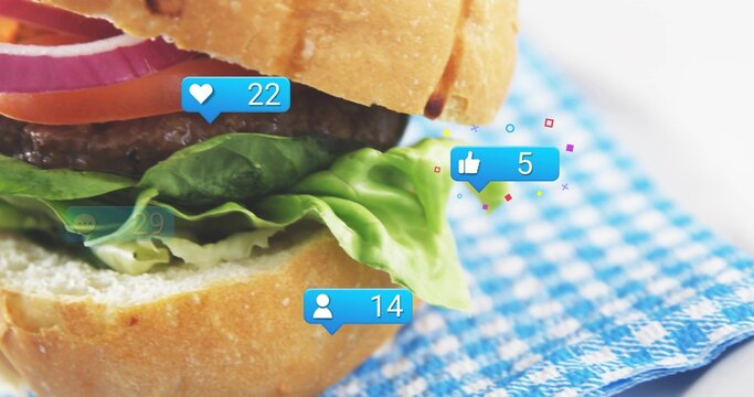 Featuring hamburger left on blue white checkered cloth, showing red onion, lettuce and social icons