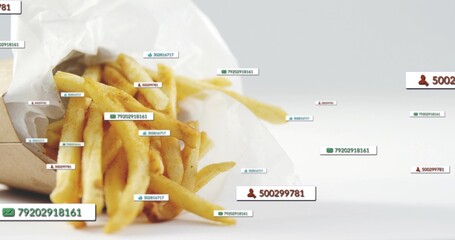Displaying paper cone of seasoned fries on white tabletop with scattered digital labels, copy space © vectorfusionart