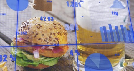 Showing seeded-bun burger with skewer and fried patty on wood table, with beer and blue overlay © vectorfusionart