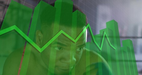 Peering shirtless man analyzing data in studio, translucent green 3D bars and jagged line graph