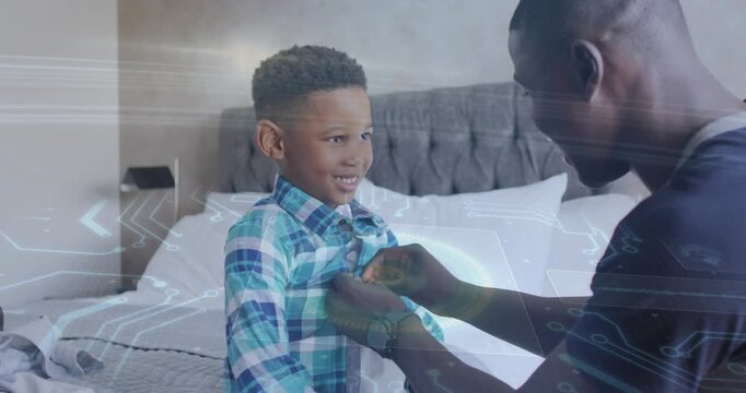 Dad approaching, fastening son's shirt buttons on bed, preparing for school with overlay on buttons