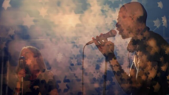 Music lead starting vocals gesturing with mic backing singer singing star bokeh over stage for fans