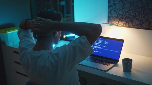 Coding workspace with laptop displaying code in dark modern interior. Coding workspace concept highlights programming process, software engineering, focused work and digital technology environment.