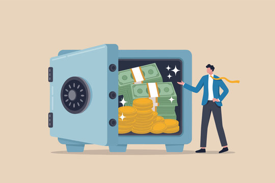Businessman standing next to a large open safe filled with stacks of cash and gold coins
