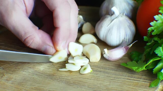 Slicing Fresh Garlic Cloves. Healthy Cooking Ingredients