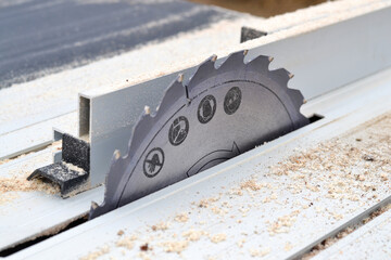 Macro shot of a sharp circular saw blade with safety icons