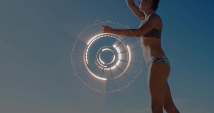 Female player tossing ball and serving overhand for sports on sunny beach, HUD drifting down