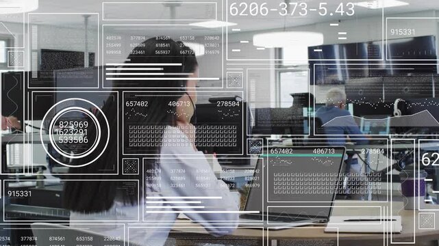 Woman using laptop in shared office, standing man tapping phone initiating HUD updating tech data