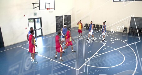Playing eight men wearing team jerseys on blue gym court, showing projected data and hoop