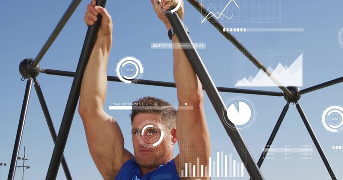 Pulling mid-adult male pulling up at outdoor gym using black frame, HUD, sleeveless blue top