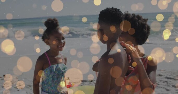 Girl laughing, gesturing triggers woman patting boy for comfort, golden bokeh over beach travel ad
