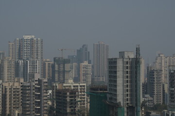 Fototapeta premium Aerial view of Mumbai buildings covered in bad AQI