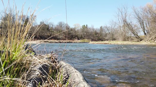 The Credit River passing through the Streetsville area of Mississauga on a sunny late winter, early spring afternoon. Shot at a high frame rate and slowed to half speed.