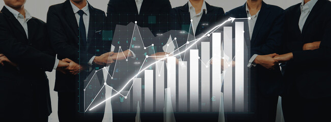A professional business team stands confidently with arms crossed, complemented by a digital chart overlay illustrating growth trends in investment and sales data. Axiom © InfiniteFlow
