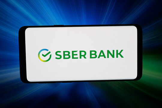 Stuttgart, Germany - 02-25-2026: In this photo illustration, the logo of Russian financial company Public JSC Sberbank is displayed on a smartphone in front of abstract background on computer screen.