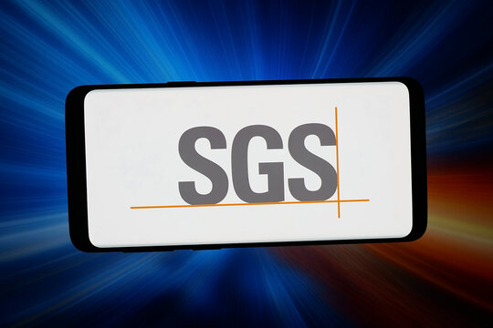 Stuttgart, Germany - 02-25-2026: In this photo illustration, the logo of Swiss testing company SGS S.A. is displayed on a smartphone in front of abstract background on computer screen.