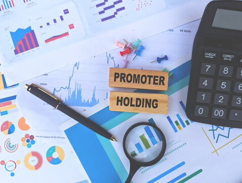 promoter holding word on wooden block