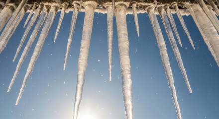 Ice Formations Hang from a Structure, Illuminated by Sunlight Against a Clear Blue Sky