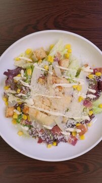 Closeup chef ipresenting delicious caesar salad on camera. slow motion. High quality FullHD footage