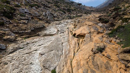 Obraz premium Rocky canyon with dry riverbed and eroded sandstone