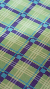 Green and Purple Plaid Pattern Background with Subtle Movement, Soft Moving Plaid Surface for Creative Branding and Social Media, vertical video