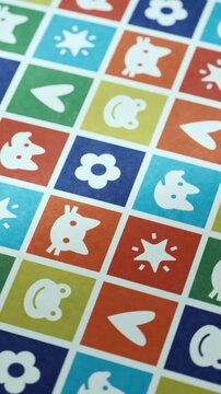 Playful Multi-Colored Grid with Cartoon Animal Faces and Symbols, Bright Patchwork Pattern of Cats, Frogs, and Stars with Soft Motion