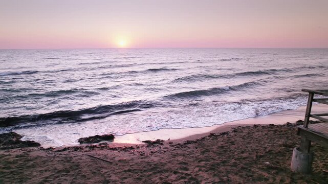 Long Beach at Dawn: Historical Steps and Waves Meeting the Shoreline in Iskele, Northern Cyprus