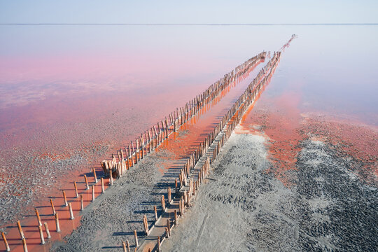 An aerial view of the picturesque Sasyk-Sivash salt lake in Crimea in August, showing wooden piles embedded in the salt.