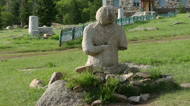  A stone woman (Kurgan stelae) on a glade on a summer sunny day. Mongolia.
