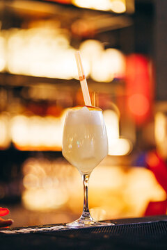 Creamy White Cocktail In Wine Glass With Straw