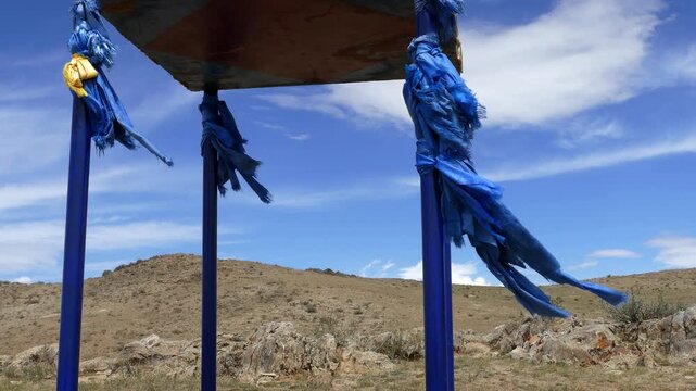 Buddhist ritual construction of stupa on the background of the picturesque cloudy sky in the Mongolian steppe. On a Sunny summer day.
