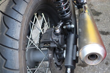 vintage classic motorcycle exhaust with a wheel © Daniel