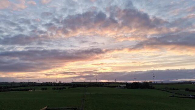 Sunset Hyperlapse Over Wind Farm in Irish Countryside &ndash; Aerial 4K 25fps