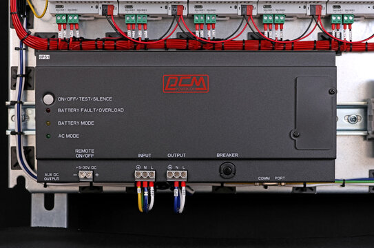 An uninterruptible power supply from Powercom is installed on a metal DKC circuit board. 