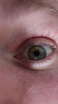 Vertical screen eye opening wider in a sudden spark of inspiration catching a bright reflection that marks the moment a new idea forms with detailed texture and focused clarity