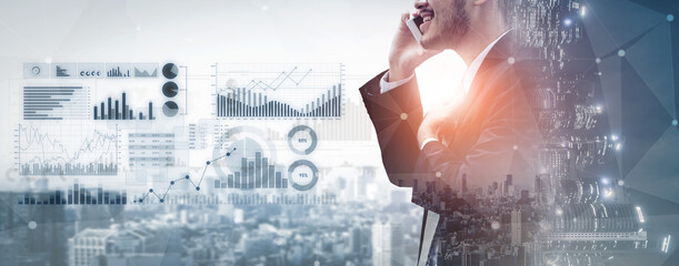 A professional businessman engaged in a phone call, analyzing financial data with graphs and...