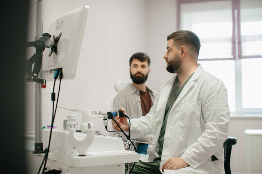 Doctor performing endoscopic examination for patient in clinic