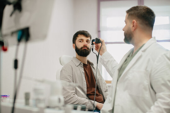 Ent doctor performing nasal endoscopy on patient