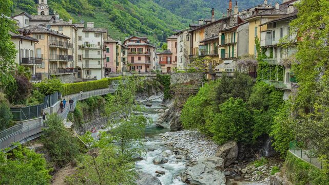 Time lapse, a mountain river flowing through a historic Alpine Italian town. Chiavenna, Lombardy, Italy.