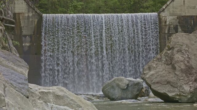 Water falls from man made cascade. Stunning waterfalls and natural beauty. Cascatella waterfall near Novate Mezzola, Italy.