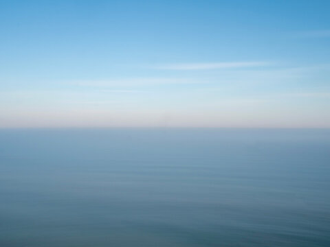 Blue sea and sky with a hazy horizon