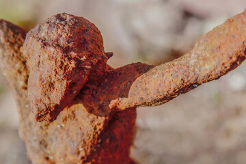 Naklejka premium Historic iron crucifix sculpture with Jesus Christ, deeply worn and authentic, expressing timeless faith, sacrifice, and spiritual resilience.