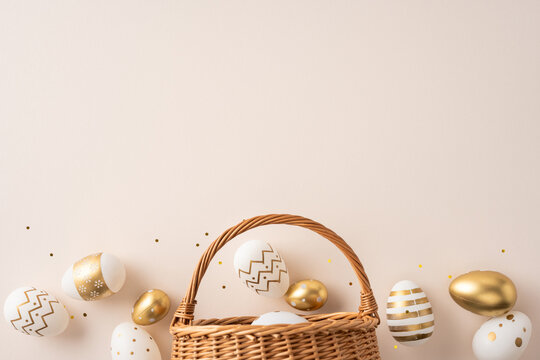 Happy Easter celebration and greeting featuring white and gold decorated eggs in a wicker basket with confetti for a festive and elegant seasonal decoration